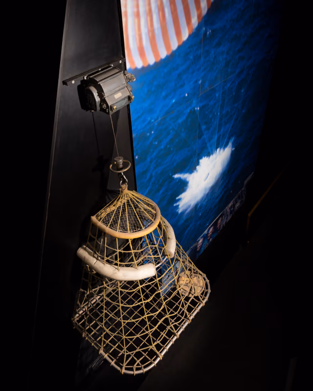 The rescue net used in the Apollo 8 recovery, a mesh sling photographed against a plain museum background.